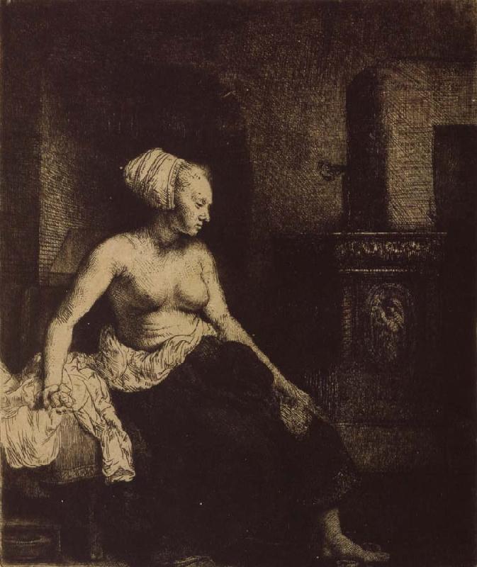  Woman sitting Half-Dressed beside a Stove